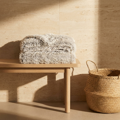 Cloudrift pet blanket folded on an oak bench